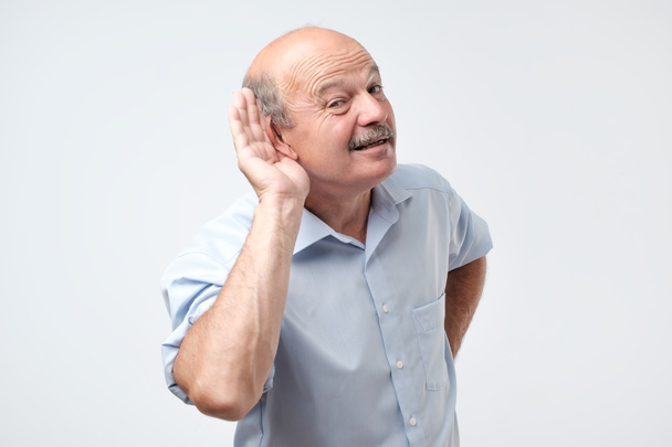 Studio Shot Of Senior Man Suffering From Deafness - Photo, Image