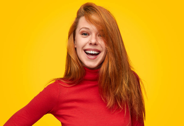 Playful flirty girl in red turtleneck  - Valokuva, kuva