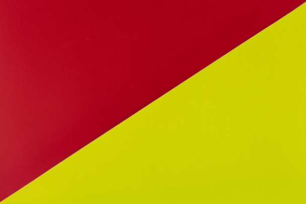Vibrant red and lime colored plastic surfaces jointed diagonally, background. - Foto, Imagem