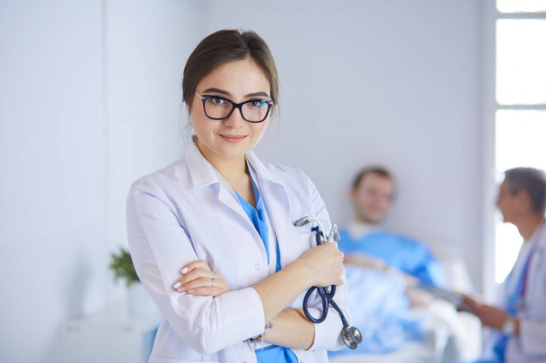 Woman doctor standing with stethoscope at hospital - Фото, зображення