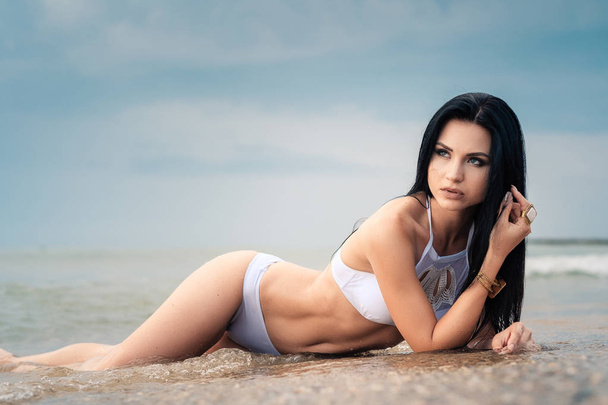 The beautiful girl in bikini on a beach - Photo, image