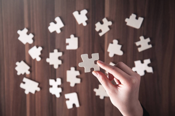 Hands holding jigsaw puzzle piece. Success and Business  - Photo, Image