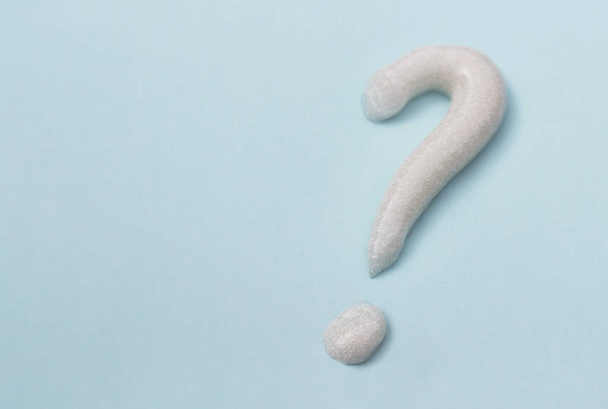Question mark from toothpaste on blue background, toothpaste selection concept - Photo, Image