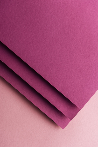 top view of blank and colorful burgundy sheets of paper on pink background with copy space  - Foto, imagen