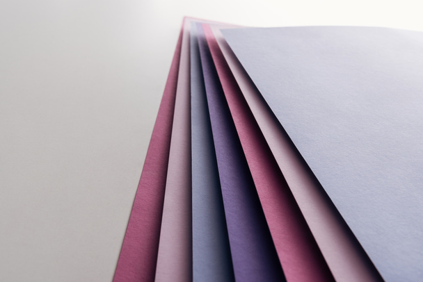 blank blue, white, pink and purple sheets of paper on white background  - Фото, изображение