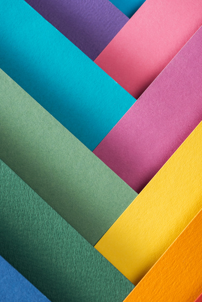 top view of blue, orange, burgundy, green, yellow, pink and purple sheets of paper  - Foto, immagini