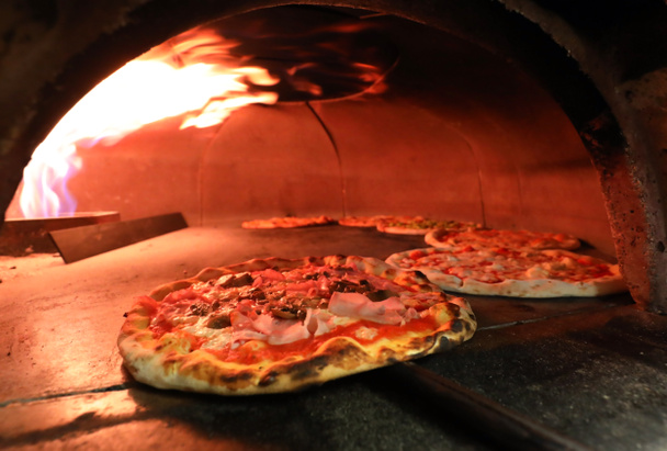 fire inside an oven of Italian pizzeria with pizzas - Photo, Image
