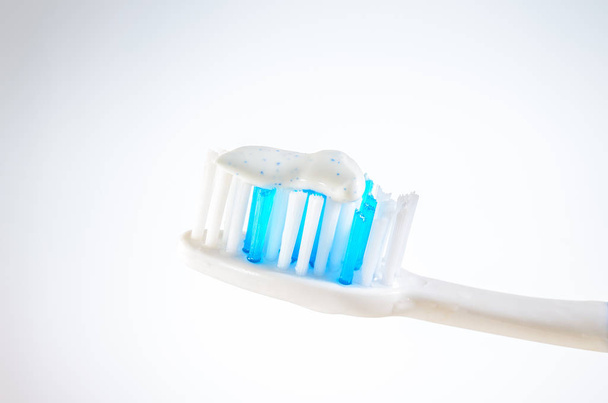 toothbrush with toothpaste on a wigh background, close up - Photo, image