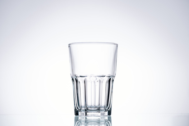 empty glass on white background with backlit and copy space - Photo, Image