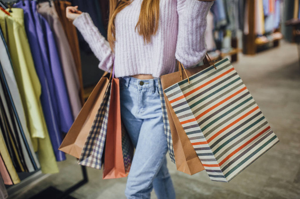 woman in casual wear with shopping bags in mall - Фото, зображення