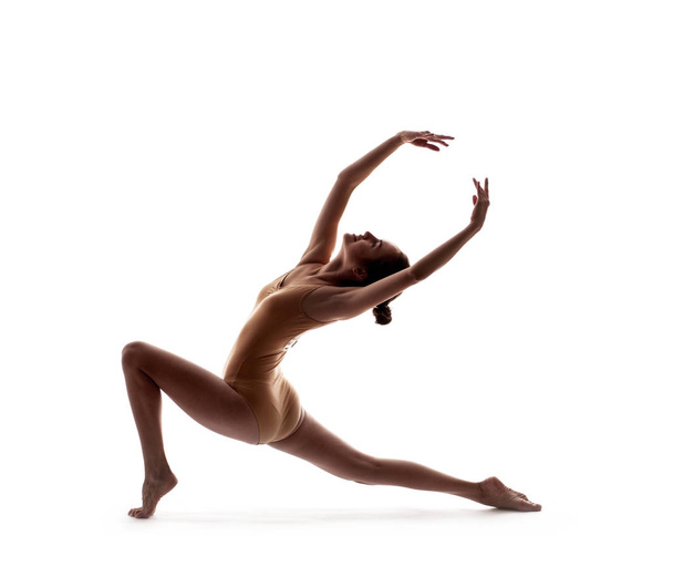 young beautiful dancer in beige swimsuit posing - Foto, Bild