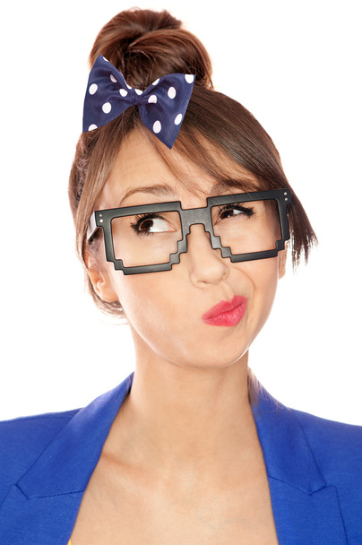 Nerdy thoughtful young brunette woman wearing 8 bit glasses - Foto, Imagen