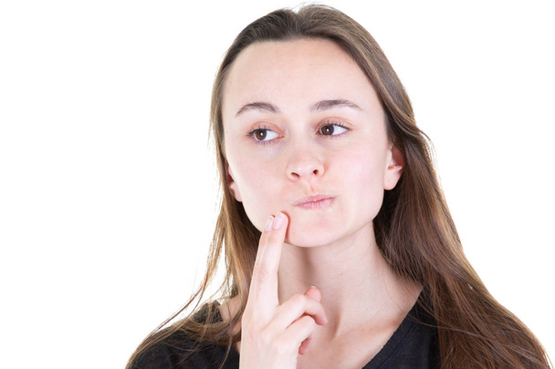 Beautiful woman wondering with her finger on chin on white background - Photo, Image