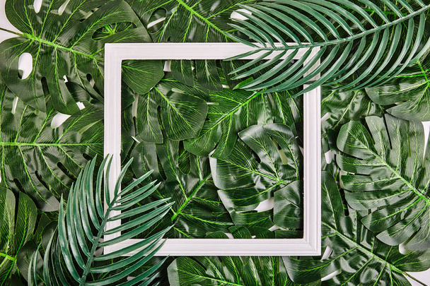 Creative layout made of tropical leaves with vintage frame. - Fotoğraf, Görsel