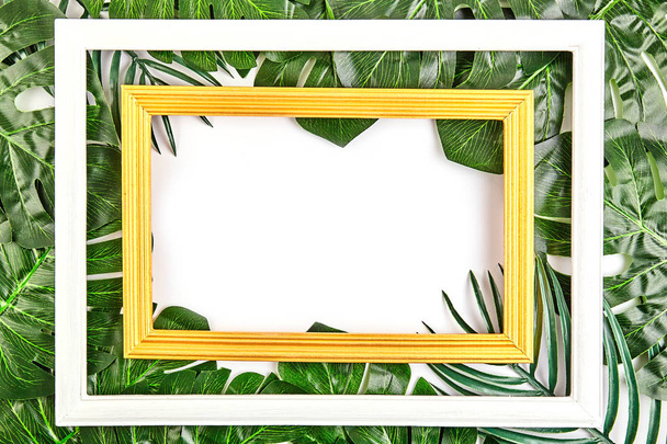 Creative layout made of tropical leaves with vintage frame. - Foto, Imagen