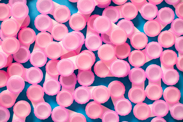 Pink contact lens cases on blue background - Foto, afbeelding