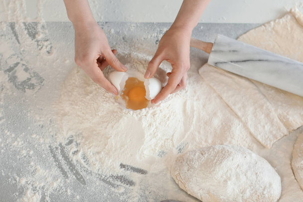 Female baker making dough in kitchen - Photo, Image