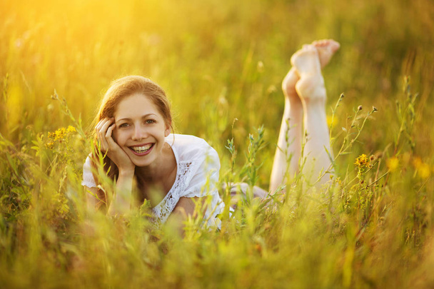 Happy girl lies in the grass - Foto, imagen