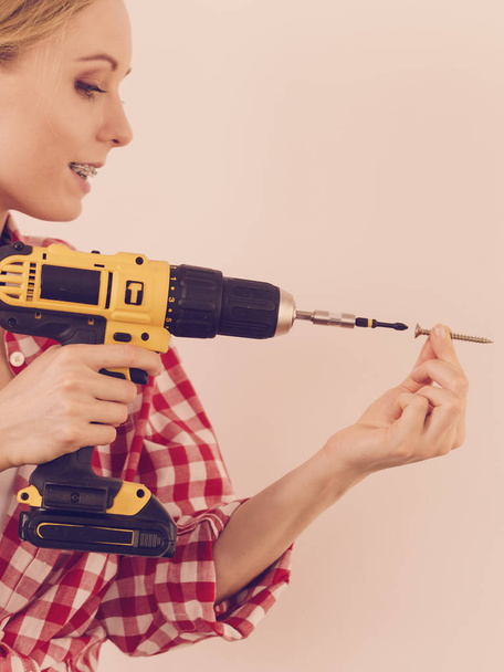 Woman drilling in wall - Photo, Image