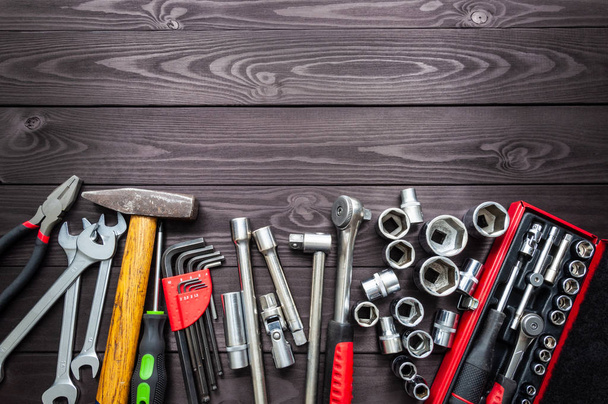 set of auto tools on dark wooden workbench. copy space - Фото, изображение
