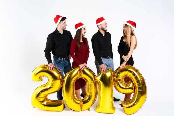 Portrait of group of friends celebrating New Year, standing with balloons with golden numbers in 2019 isolated on white background - Φωτογραφία, εικόνα