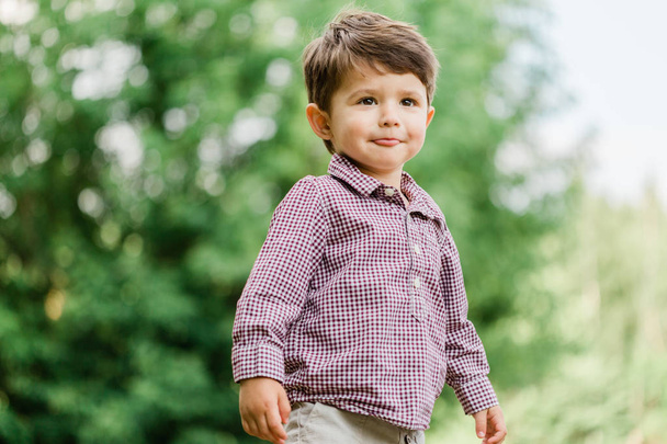 Cheerful cute little boy having fun in park. Happy childhood. - Fotografie, Obrázek