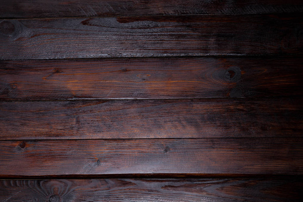 Tmavé dřevěné pozadí. Abstraktní textura. Pohled shora z dřevěných desek - Fotografie, Obrázek