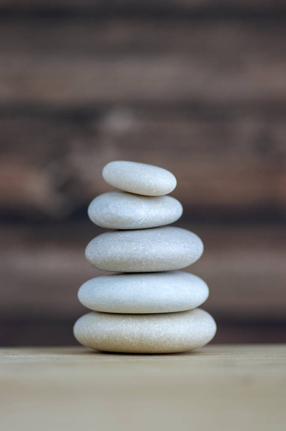 Harmony and balance, cairns, simple poise stones on white background, rock zen sculpture, five white pebbles, single tower, simplicity - Zdjęcie, obraz