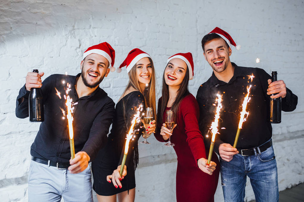 group of friends drinking champagne and celebrating new year isolated on white background - Фото, изображение