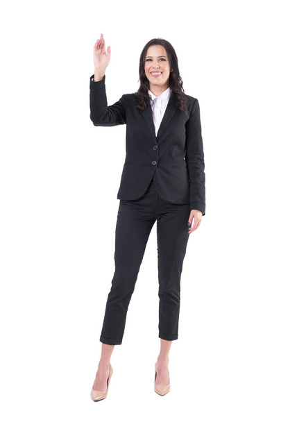 Friendly smiling happy business woman in elegant suit meeting and greeting with waving hand. Full body isolated on white background.  - Photo, Image