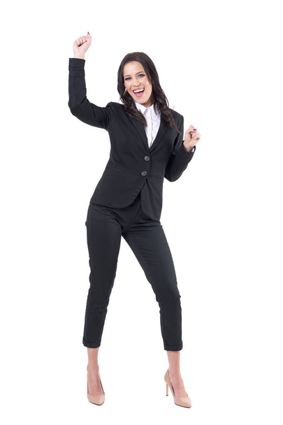 Excited joyful business woman in formal clothes dancing and celebrating looking at camera. Full body isolated on white background.  - Photo, image