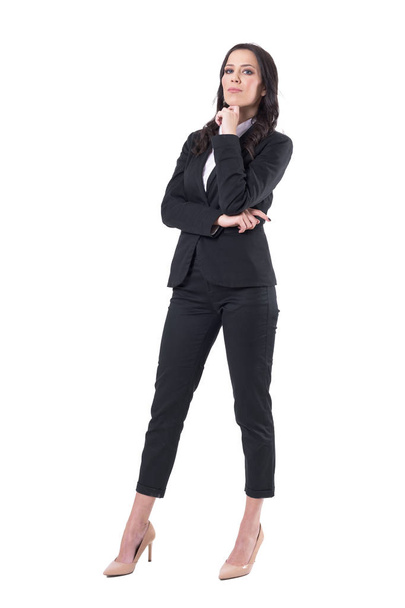 Elegant beautiful caucasian business woman in suit posing with finger under chin. Full body isolated on white background.  - Фото, изображение