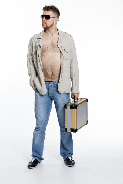 macho man in the jacket on a naked body with a portfolio - Foto, Bild