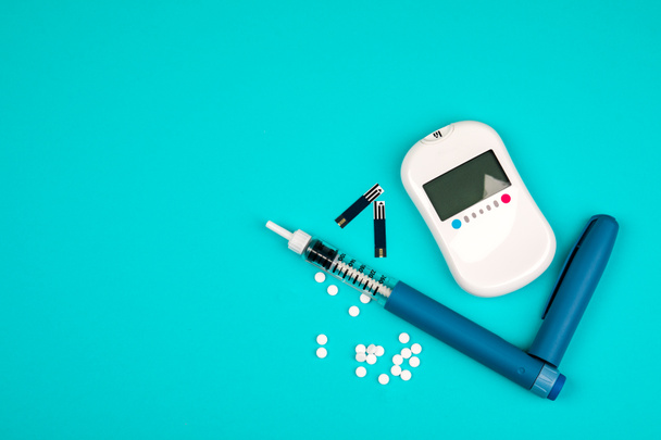Diabetes. Diabetes-käsite. Glukoosimittari ja injektiot insuliinille sinisellä pohjalla. Diabeettiset tarvikkeet
 - Valokuva, kuva