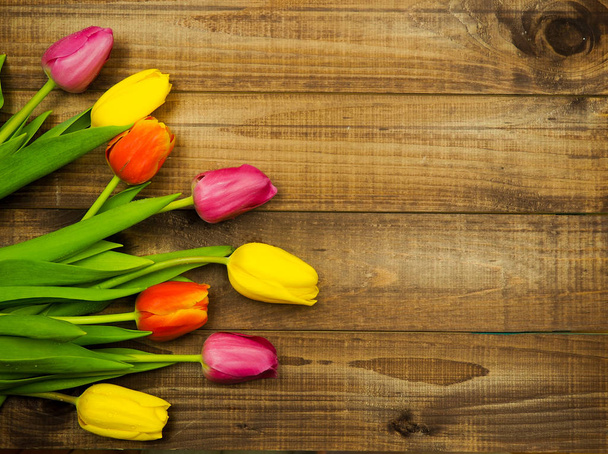 Yellow tulips on wooden background copy space - Фото, изображение