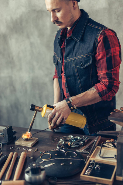 craftsman concentrated on working with flame - Photo, image