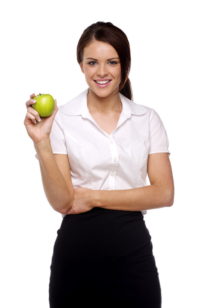 Business woman holding at an apple - Foto, afbeelding