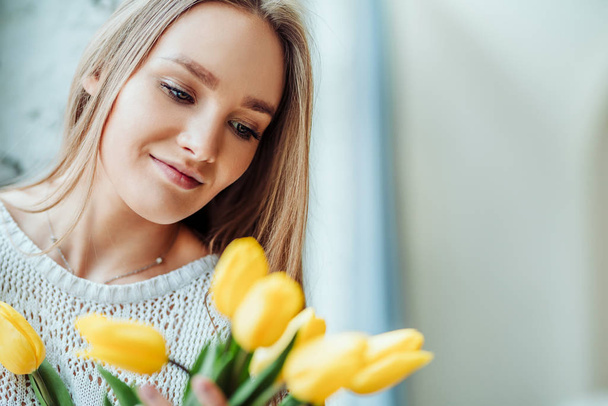 Portrait of beautiful woman with bouquet of tulips. Love and tenderness concept. - Fotografie, Obrázek