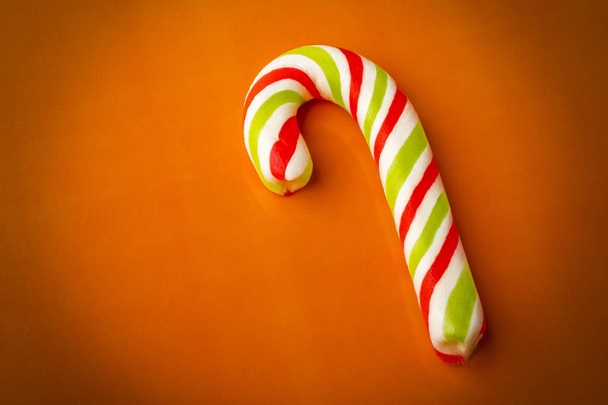 Christmas Candy Cane on orange Background. Copy space  - Foto, immagini