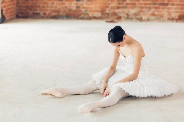 ballet dancer is tired after working out. - Zdjęcie, obraz
