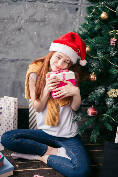 positive good looking girl hugging her gift box - Valokuva, kuva