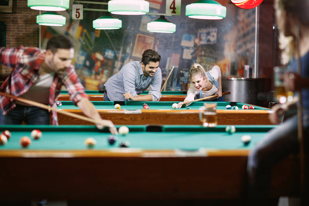 billiard games - people enjoying playing pool together - Fotografie, Obrázek