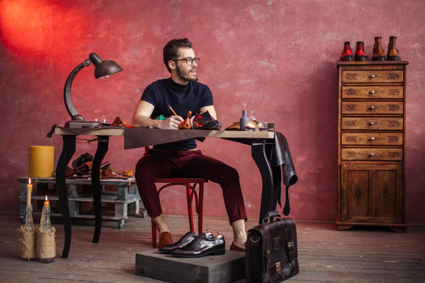 young creative shoemaker inventing stylish shoes - Foto, Bild
