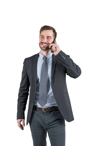Smiling businessman talking on smartphone isolated - Foto, Bild