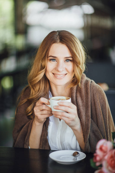 beautiful blond woman drinking coffee on summer terrace  - Foto, Imagem