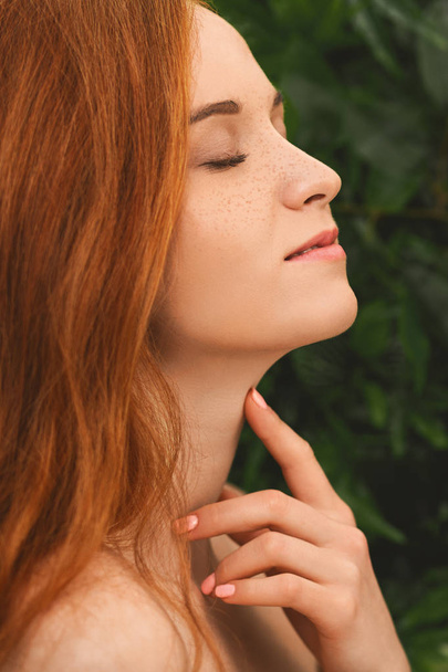 Young redhead girl enjoying her neck skin - Photo, Image