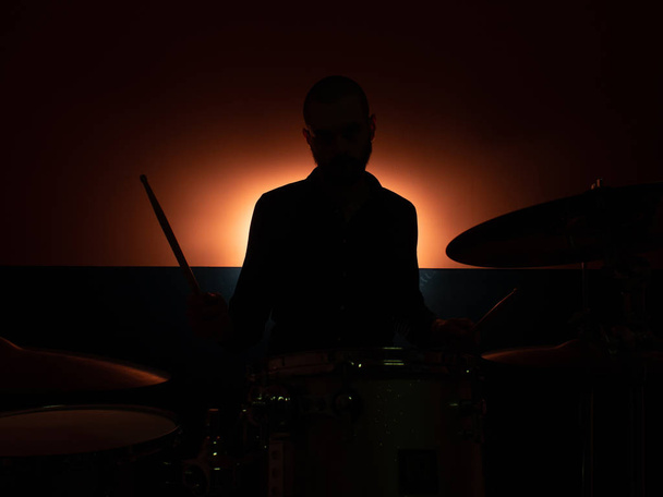 Boy playing drum with backlight - Foto, Imagen