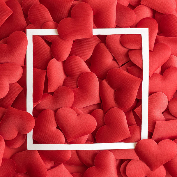 Love concept made of small hearts in red color and frame abstract. - Foto, immagini