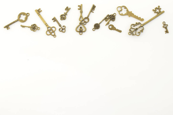 Decorative keys of different sizes, stylized antique on a white background. At the top of the frame - Photo, image