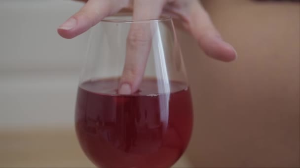Woman taste wine with finger - Filmati, video